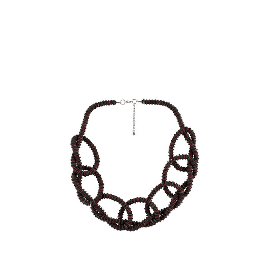 Handmade wooden necklace with flat disc round beads in spiral design, crafted by a sustainable fashion accessories manufacturer. Unique, eco-friendly, and stylish.